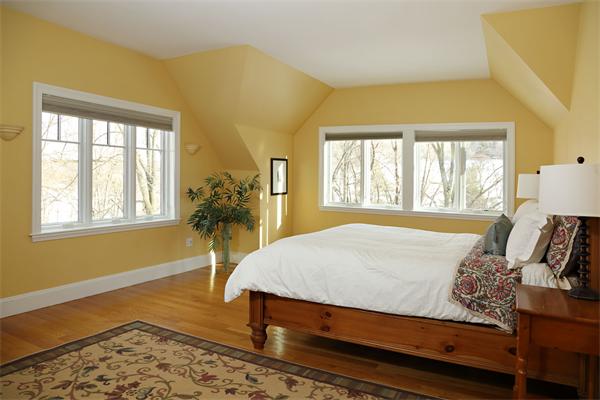 1 Valley Spring Road Newton, MA 02458 - Photo 7 of 10 a bed sitting in a bedroom next to a window