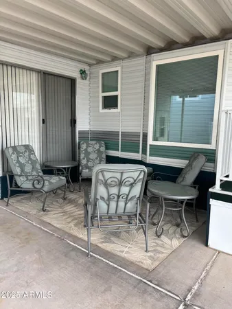 a view of patio with couple of chairs