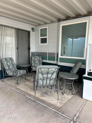 a view of patio with couple of chairs