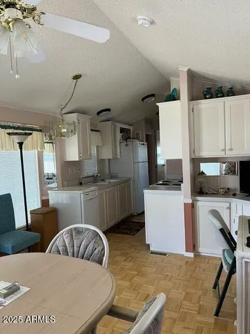a living room with stainless steel appliances kitchen island granite countertop furniture and a view of kitchen