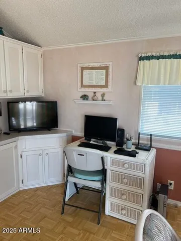 a bedroom with furniture and a flat screen tv