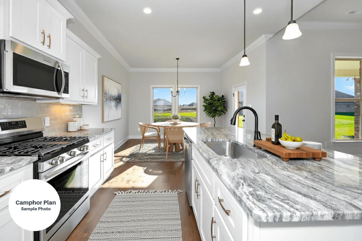 2740 Louis Circle Crestview, FL 32536 - Photo 2 of 8 a kitchen with stainless steel appliances granite countertop a stove a sink and a microwave