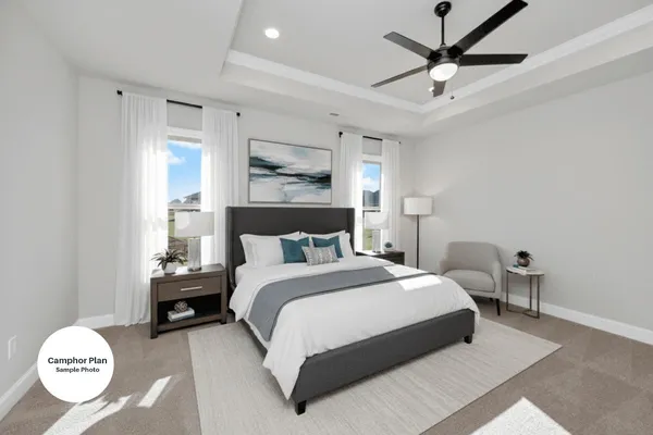 a bedroom with a bed mirror and a window