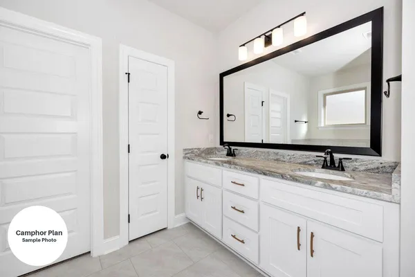 a bathroom with a granite countertop sink mirror and a