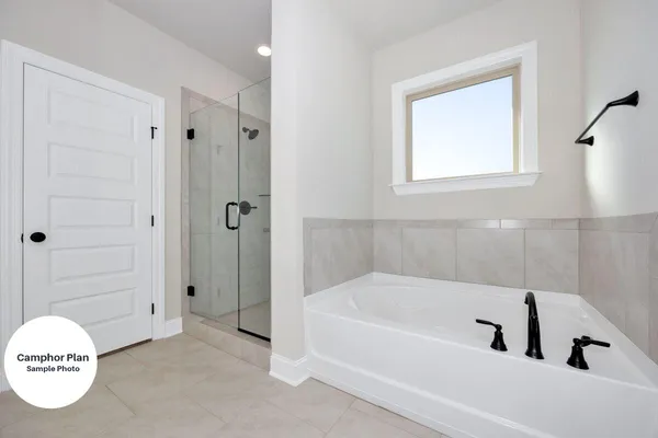 a bathroom with a tub and a shower