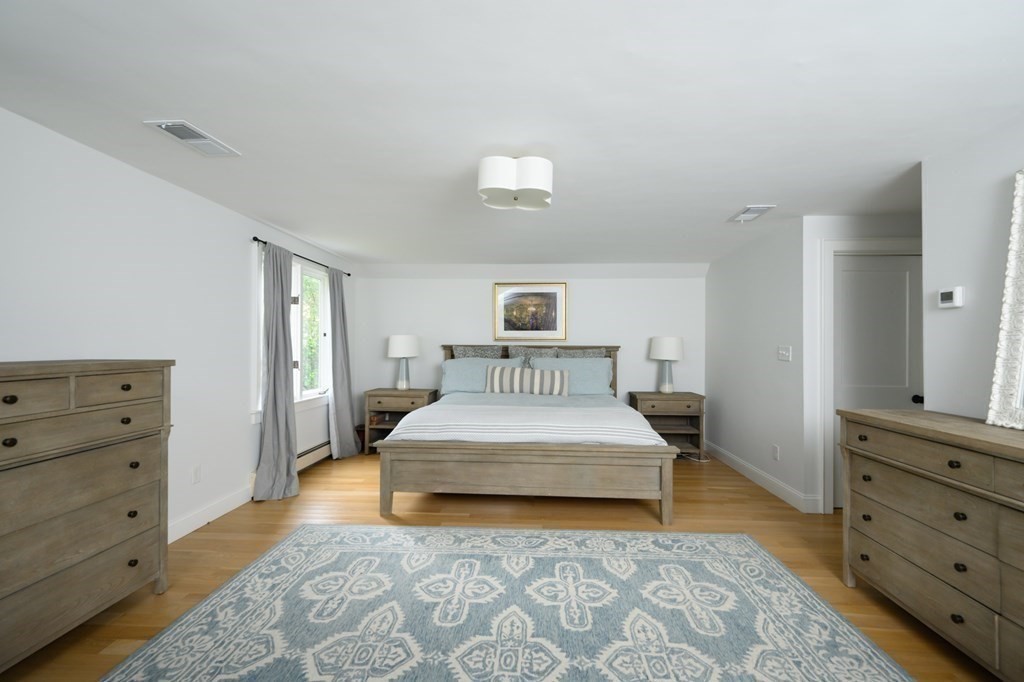 58 Jerusalem Road Cohasset, MA 02025 - Photo 17 of 24 a spacious bedroom with a bed and a dresser in it