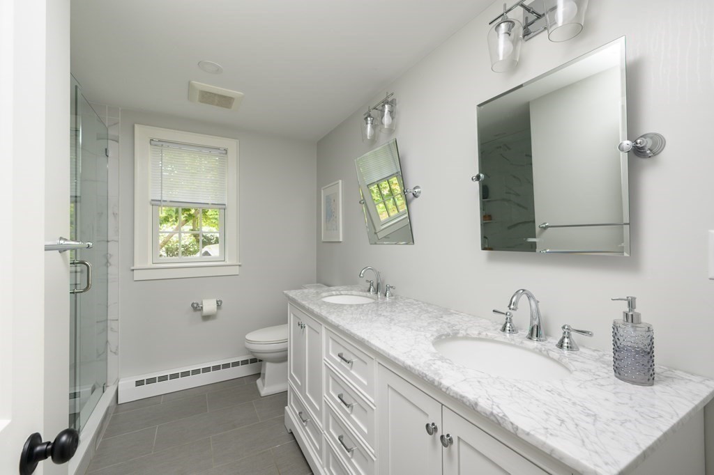 58 Jerusalem Road Cohasset, MA 02025 - Photo 18 of 24 a bathroom with a granite countertop double vanity sink mirror and toilet