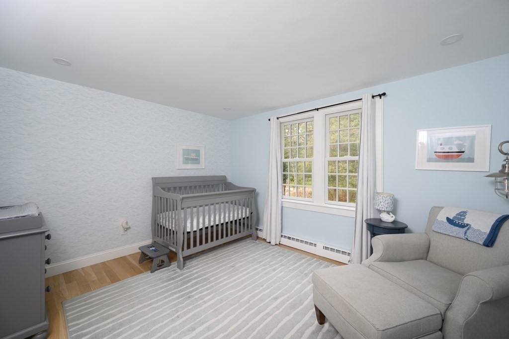 58 Jerusalem Road Cohasset, MA 02025 - Photo 19 of 24 a bedroom with a bed and wooden floor