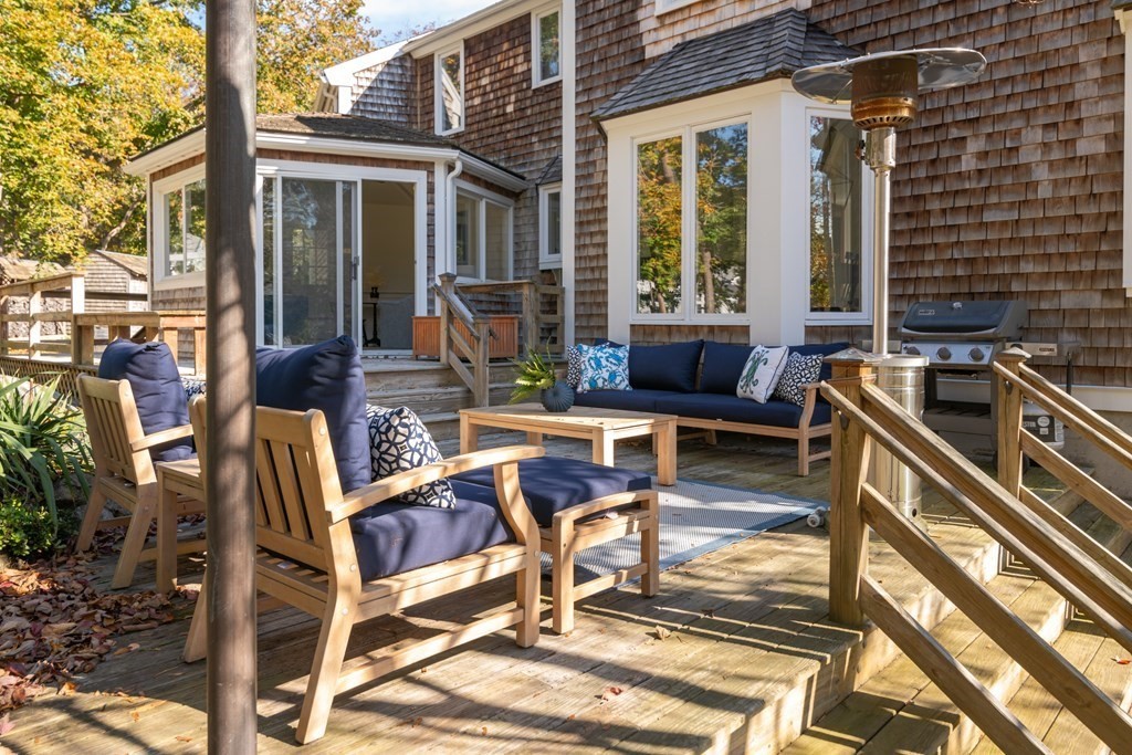 58 Jerusalem Road Cohasset, MA 02025 - Photo 22 of 24 a view of a patio with table and chairs with wooden floor and fence