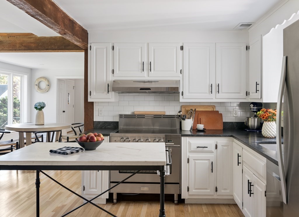 58 Jerusalem Road Cohasset, MA 02025 - Photo 4 of 24 a kitchen with a stove a refrigerator and cabinets