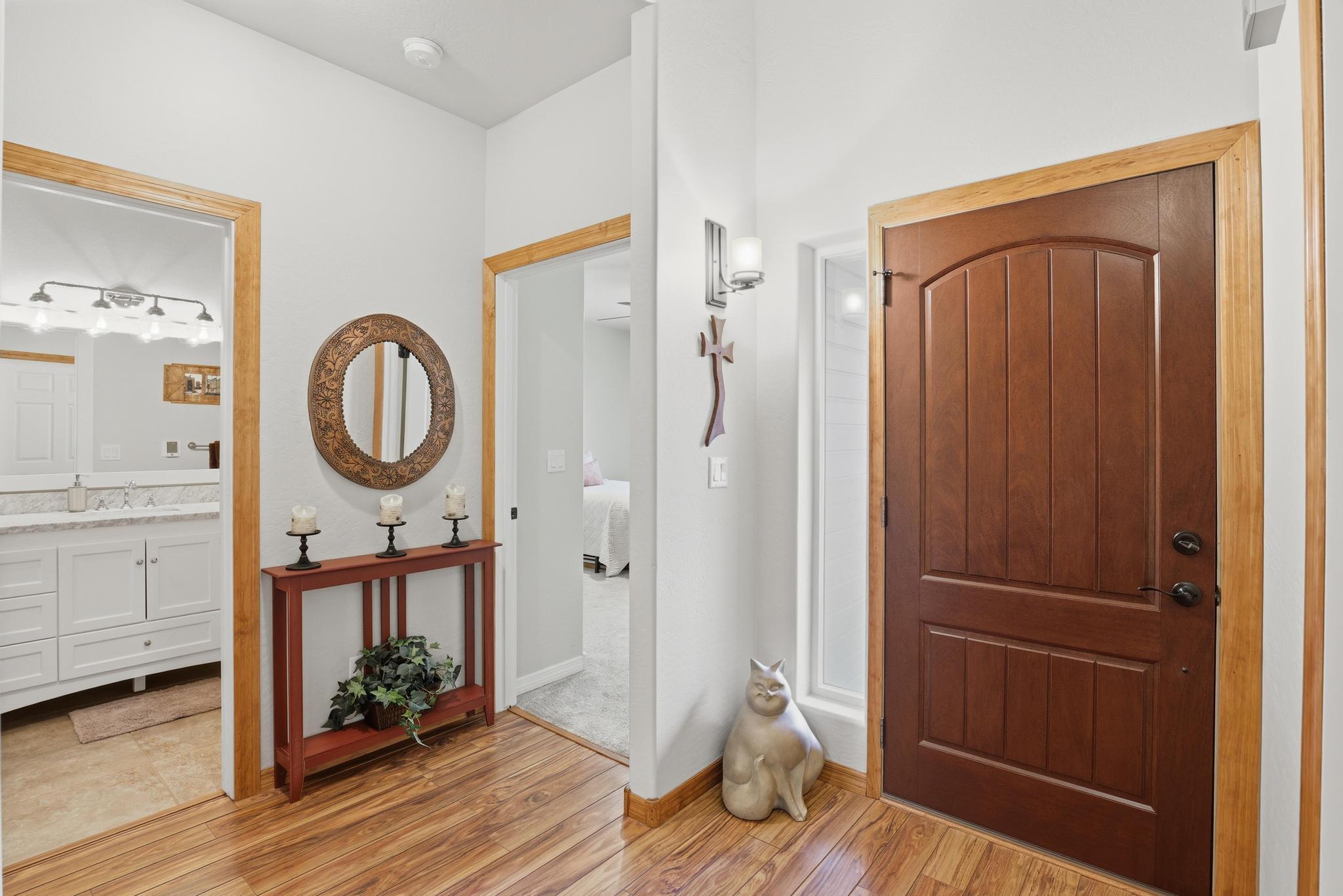 5501 Solitude Trail Loop Pine, AZ 85544 - Photo 6 of 27 a view of a hallway with wooden floor and a bathroom