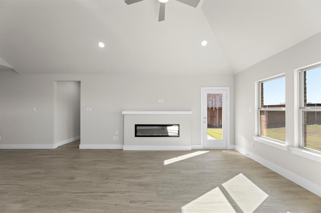 2359 Bell Way Forney, TX 75126 - Photo 10 of 31 a view of an empty room with a window and fire place