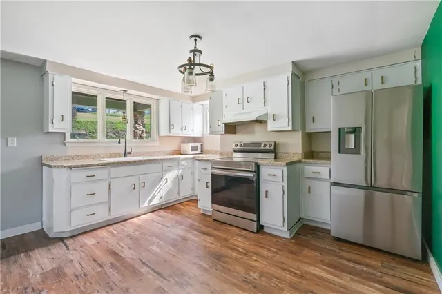 a kitchen with a refrigerator stove and sink