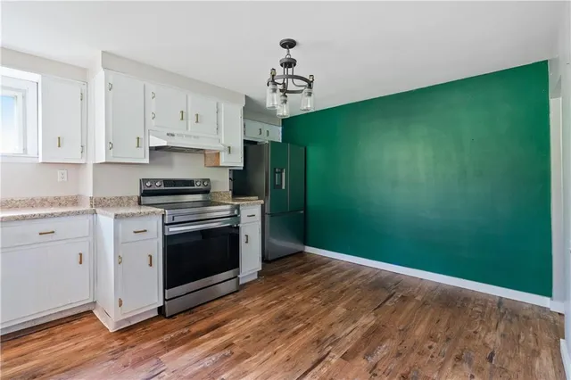 a kitchen with a sink stainless steel appliances and cabinets