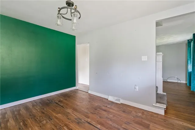 a view of a room with wooden floor