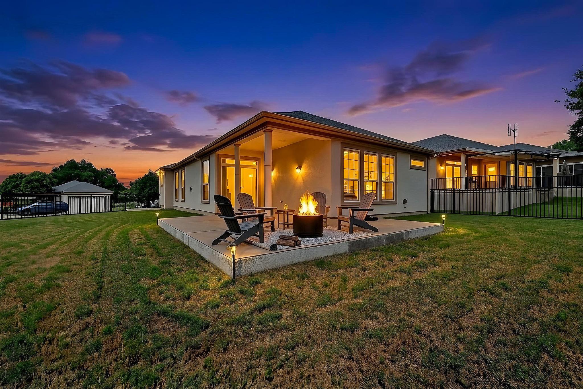 520 Mill Pond Path Georgetown, TX 78633 - Photo 36 of 38 An inviting backyard oasis awaits with a spacious patio, a crackling fire pit, and ample room for relaxation. (Virtually staged)