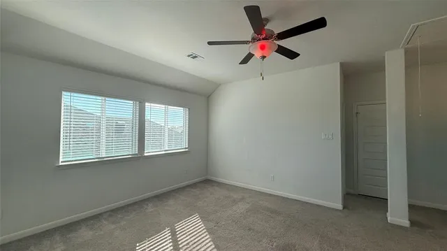 a view of a livingroom with a ceiling fan and window