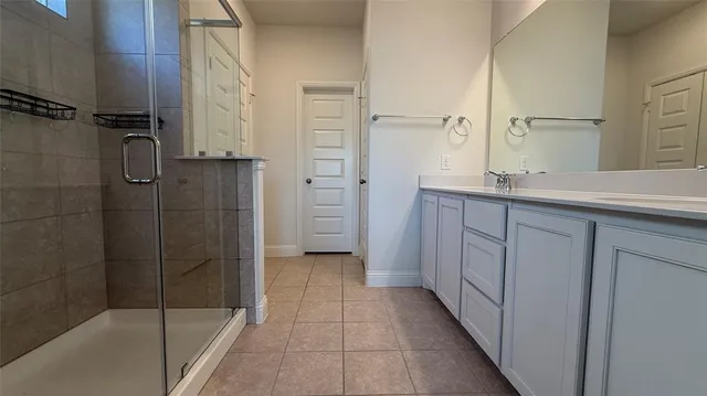 a bathroom with a shower and a sink