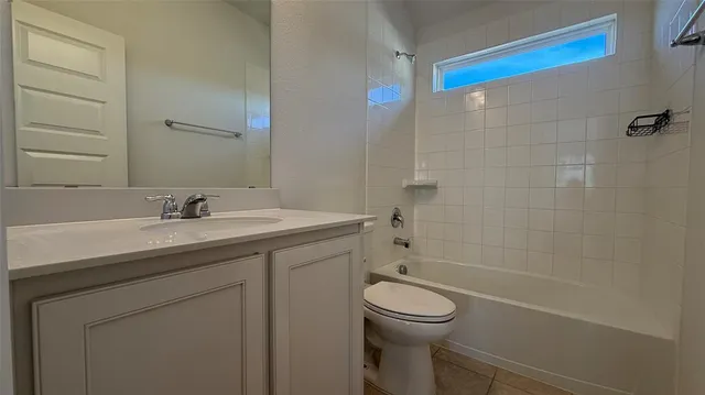 a bathroom with a granite countertop sink a toilet and shower