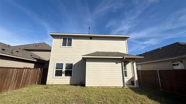a view of house with backyard