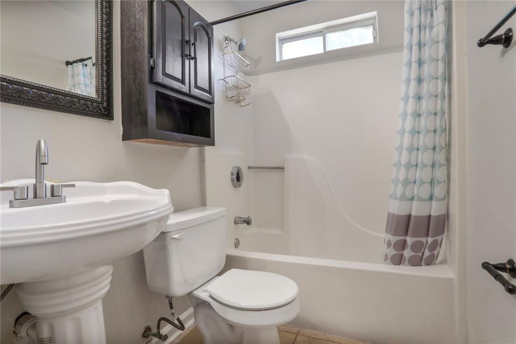 3756 Old Oak Court Powder Springs, GA 30127 - Photo 12 of 14 a bathroom with a sink a toilet and shower