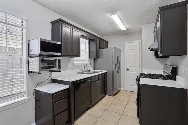 a kitchen with a stove a sink and a refrigerator