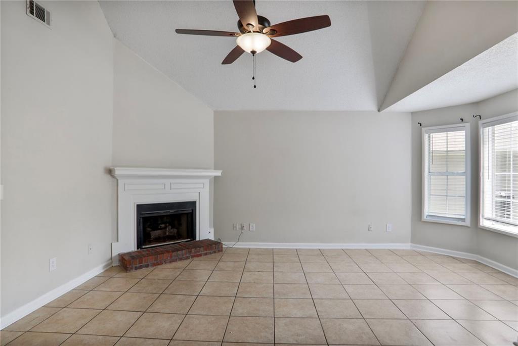 3756 Old Oak Court Powder Springs, GA 30127 - Photo 4 of 14 an empty room with windows and fireplace