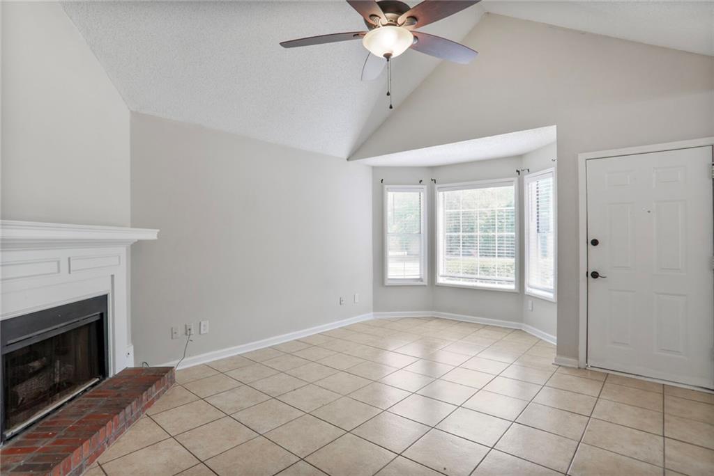 3756 Old Oak Court Powder Springs, GA 30127 - Photo 5 of 14 a view of an empty room with a fireplace and a window