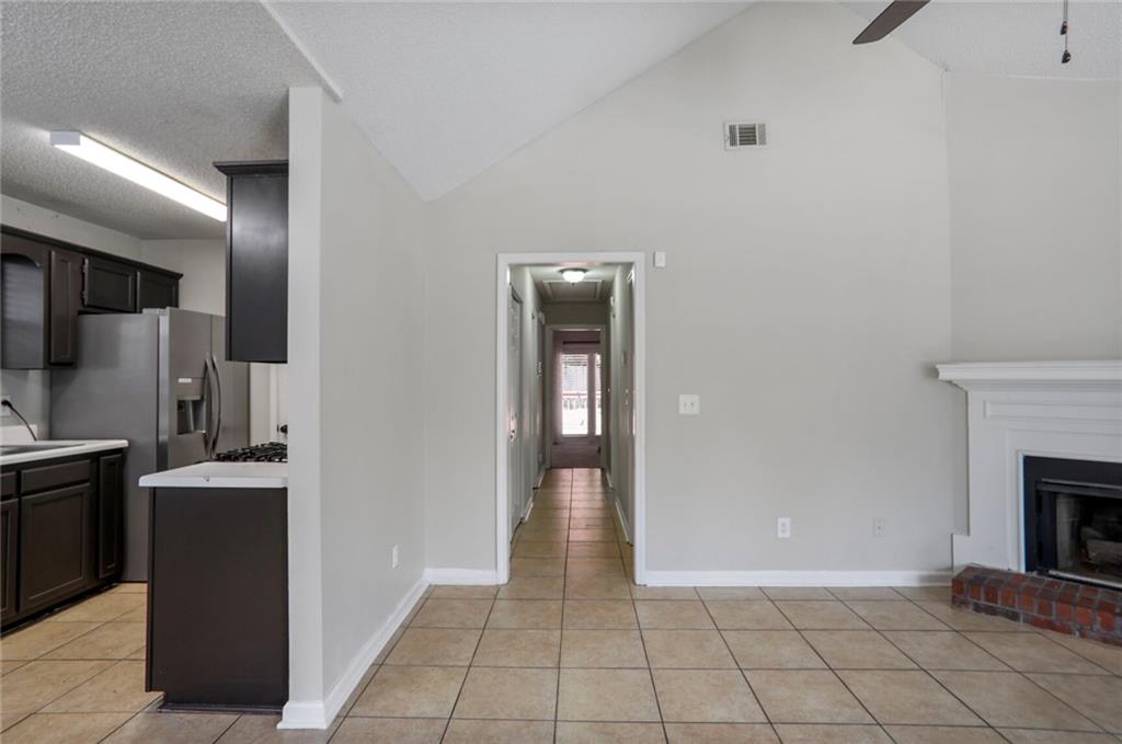 3756 Old Oak Court Powder Springs, GA 30127 - Photo 6 of 14 a view of a kitchen from the hallway with a fireplace