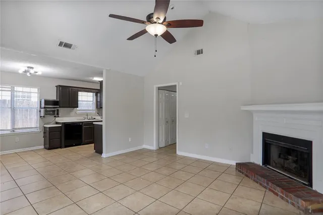 a large kitchen with a stove and a fireplace