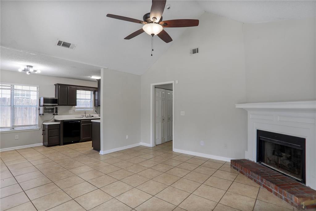 3756 Old Oak Court Powder Springs, GA 30127 - Photo 7 of 14 a large kitchen with a stove and a fireplace