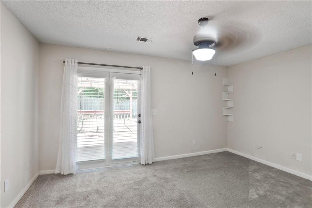 3756 Old Oak Court Powder Springs, GA 30127 - Photo 8 of 14 an empty room with a window and a kitchen