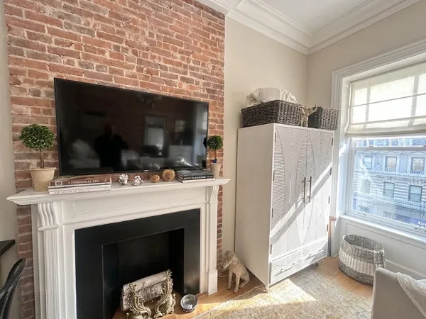 a view of living room with furniture and a fireplace
