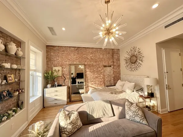 a living room with furniture and a chandelier