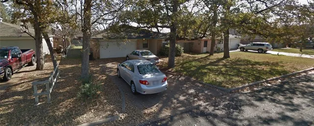 a view of a backyard with table and chairs and a fire pit