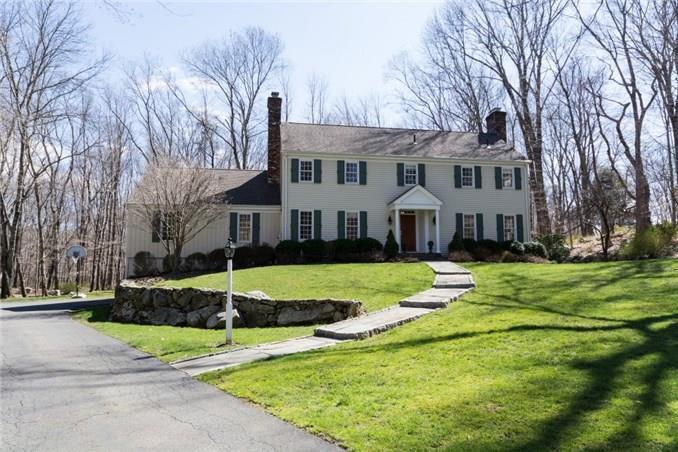 41 Pumping Station Road Ridgefield, CT 06877 - Photo 1 of 1 a front view of a house with a yard table and chairs