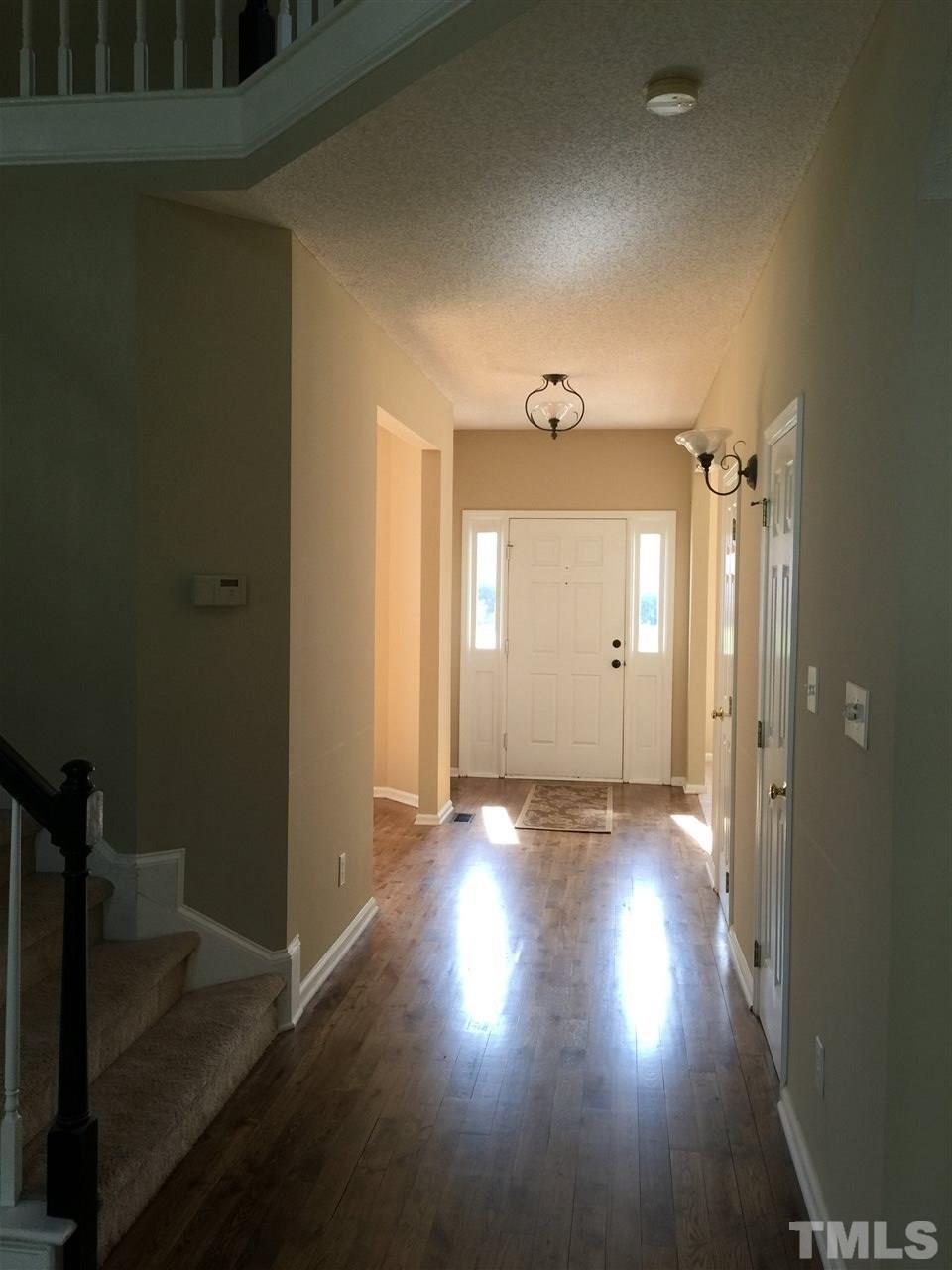12109 Amoretto Way Raleigh, NC 27613 - Photo 6 of 8 a view of empty room with wooden floor