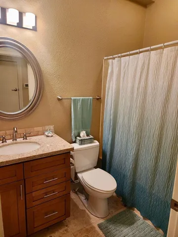 a bathroom with a toilet a sink and a mirror