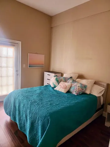 a bedroom with a bed and cabinets