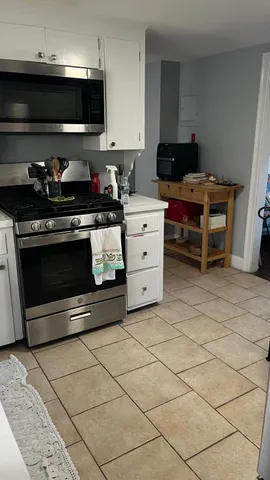 a kitchen with stainless steel appliances a stove a sink and a microwave