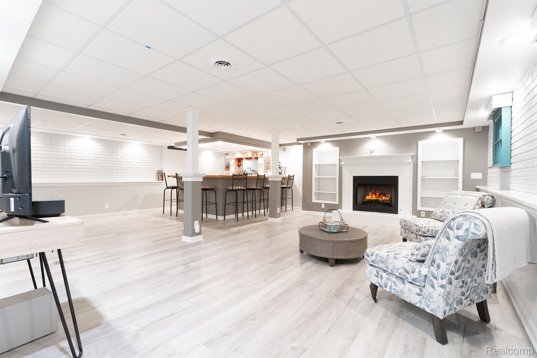 6884 West Lange Road Fowlerville, MI 48836 - Photo 31 of 59 GAS FIREPLACE AND WET BAR W/FRIGERATOR ON FAR LEFT