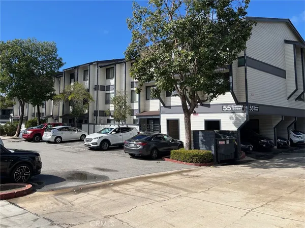 a view of a cars park in front of a building