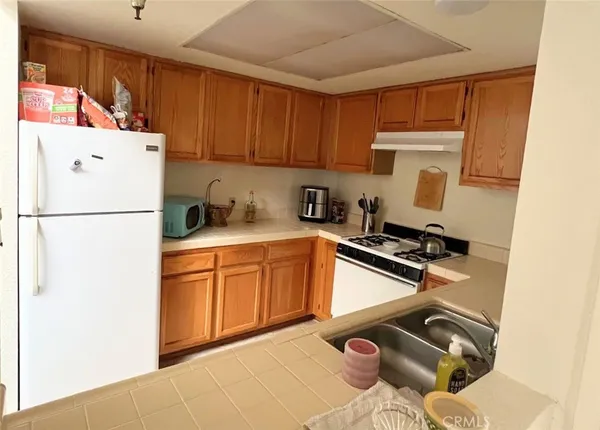 a kitchen with a refrigerator and a stove top oven