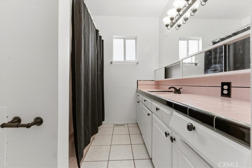 34863 Wildwood Canyon Road Yucaipa, CA 92399 - Photo 11 of 22 a view of a bathroom with a sink and mirror