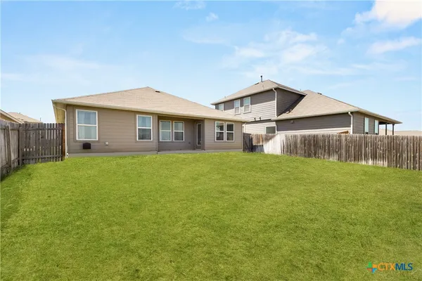 a front view of a house with a garden and yard