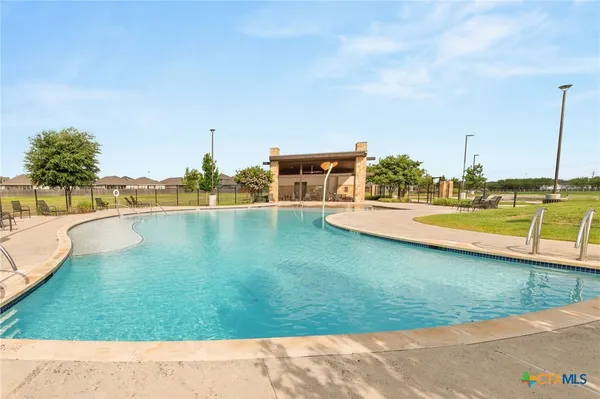 a view of a swimming pool with a lawn chairs