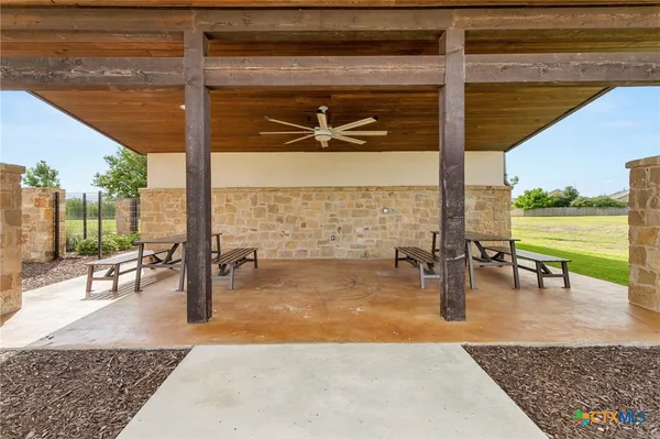 a view of swimming pool with lawn chairs and couches
