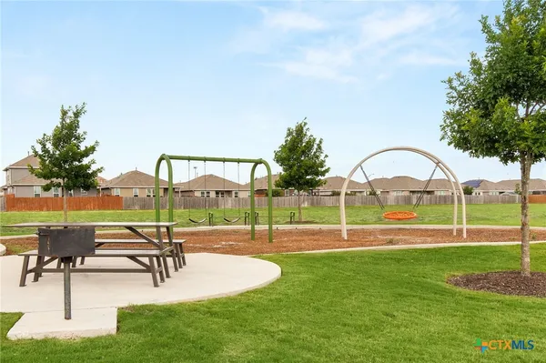 a swimming pool with outdoor seating and garden