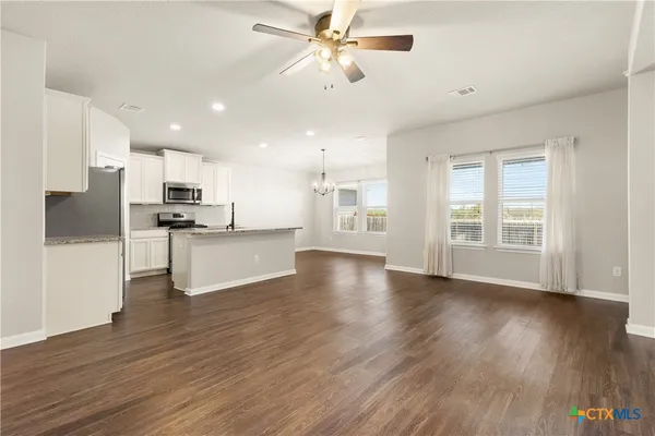 a view of kitchen with cabinets wooden floor and a kitchen