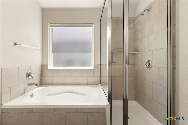 a bathroom with a tub and shower